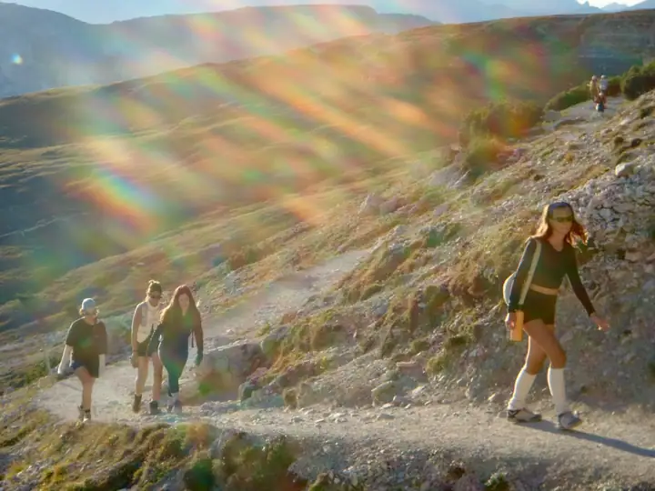 Hikers on a sunlit mountain trail