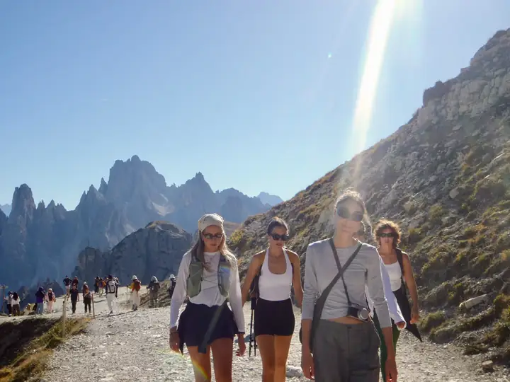 Friends walking a sunny mountain trail together