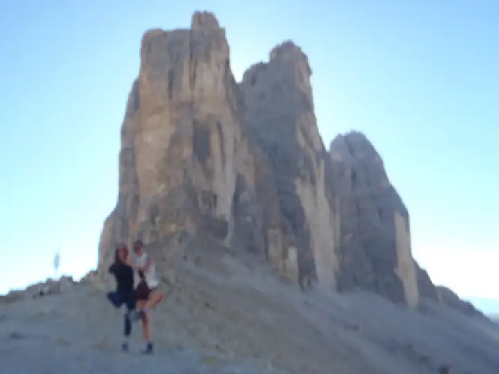 A hiker below the Tre Cime towers
